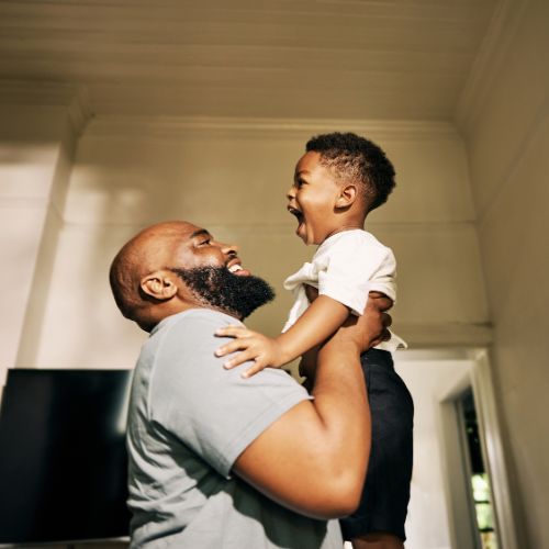 father holding child